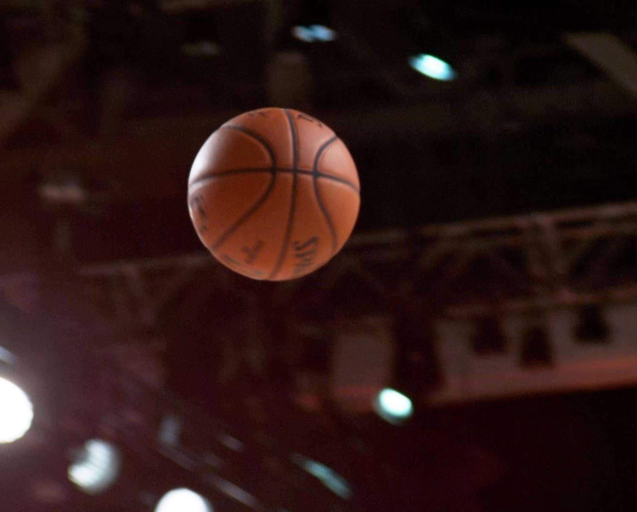 A basketball flies through the air
